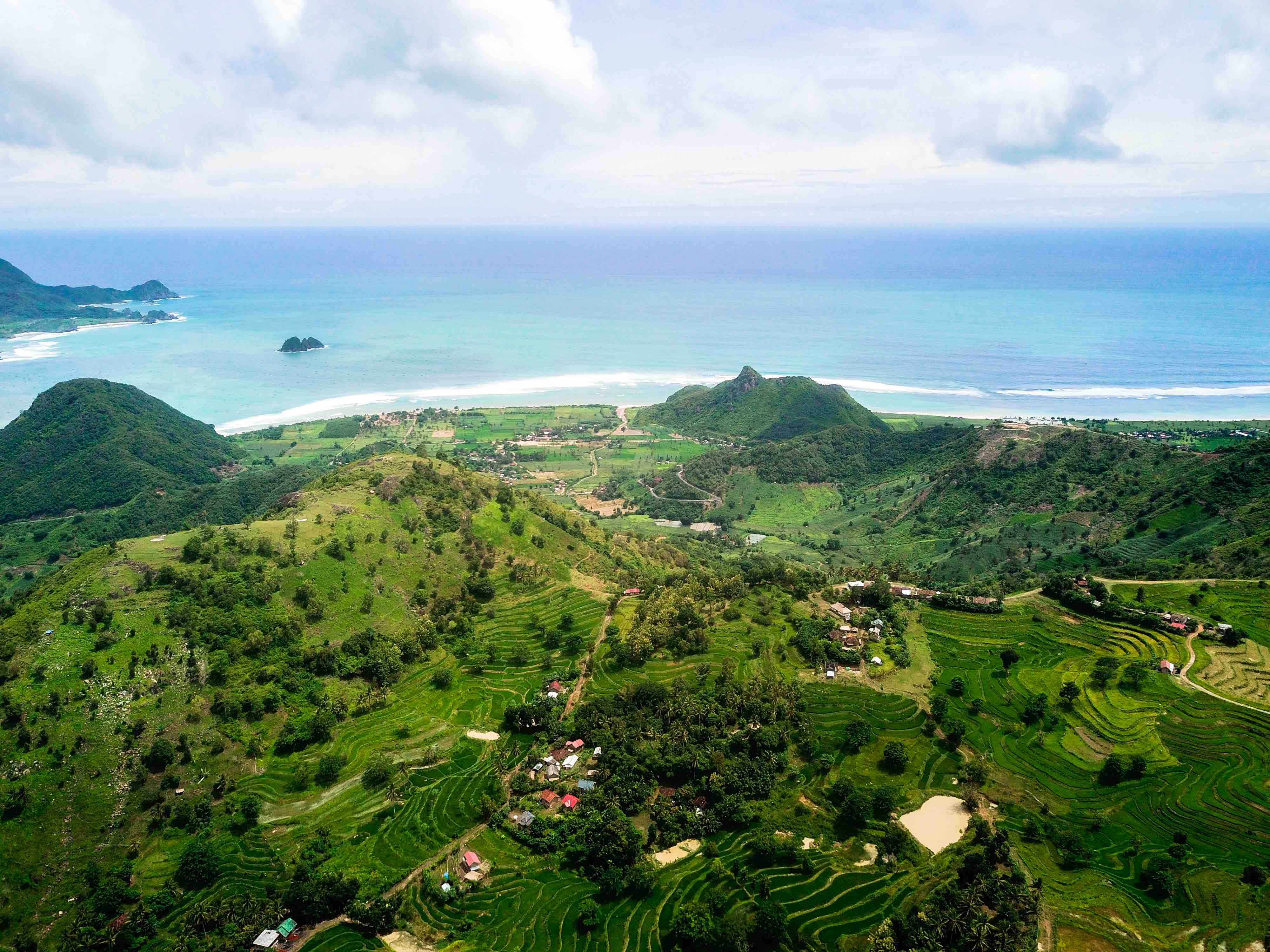 Aerial view of Kuta Lombok coastline and green hills