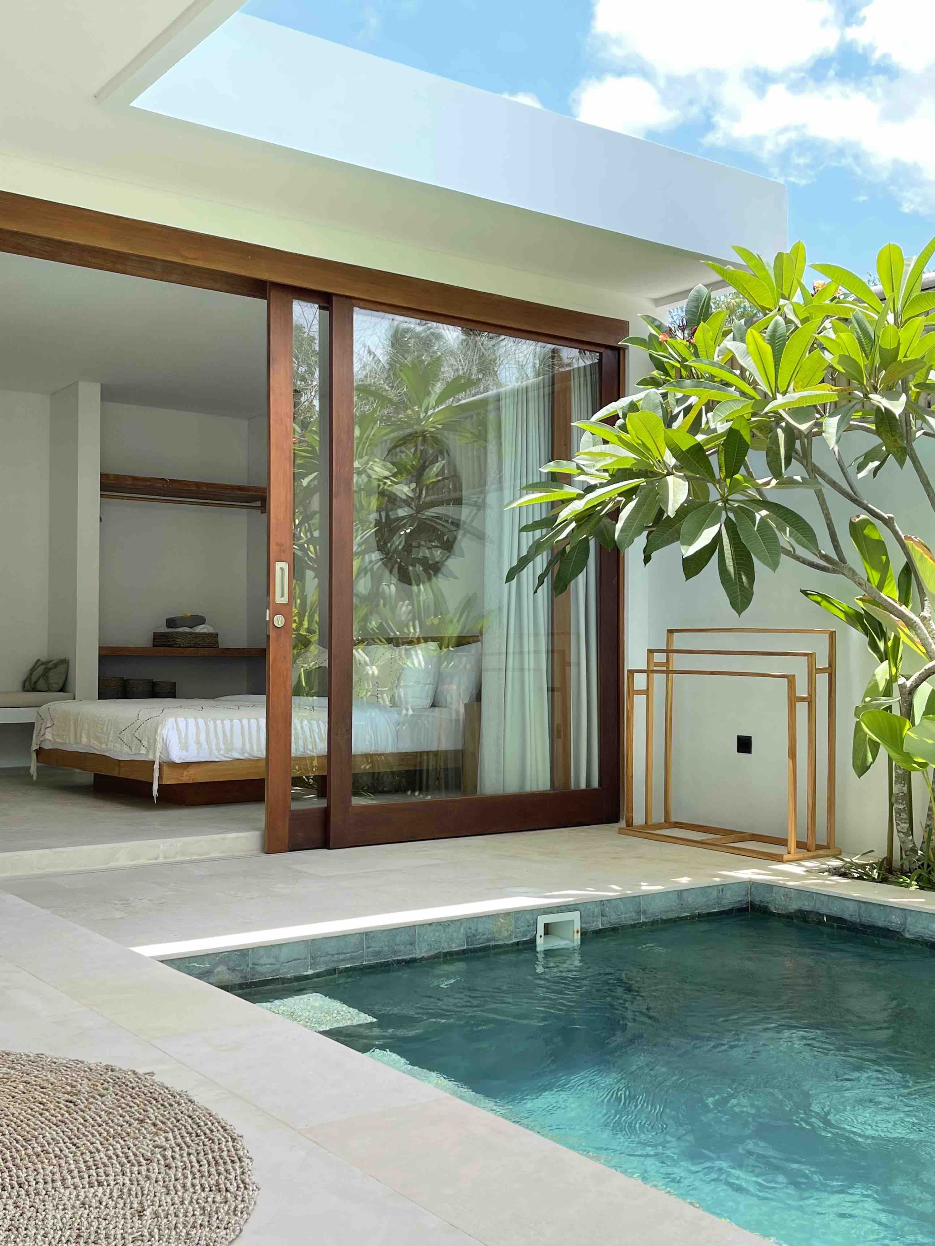 Villa bedroom opening onto a private pool